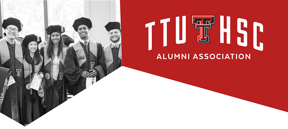 Group of TTUHSC graduates beside the alumni association logo