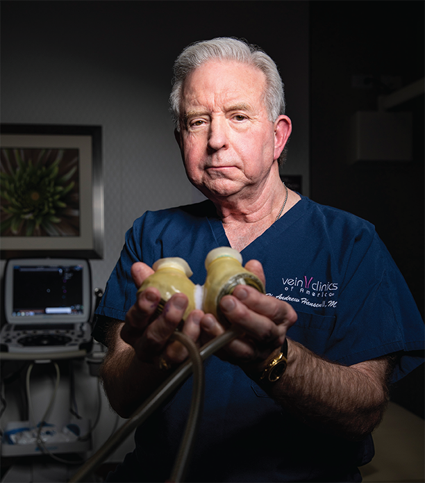 H. Andrew Hansen holds a model of the Jarvik heart he keeps in his office. 