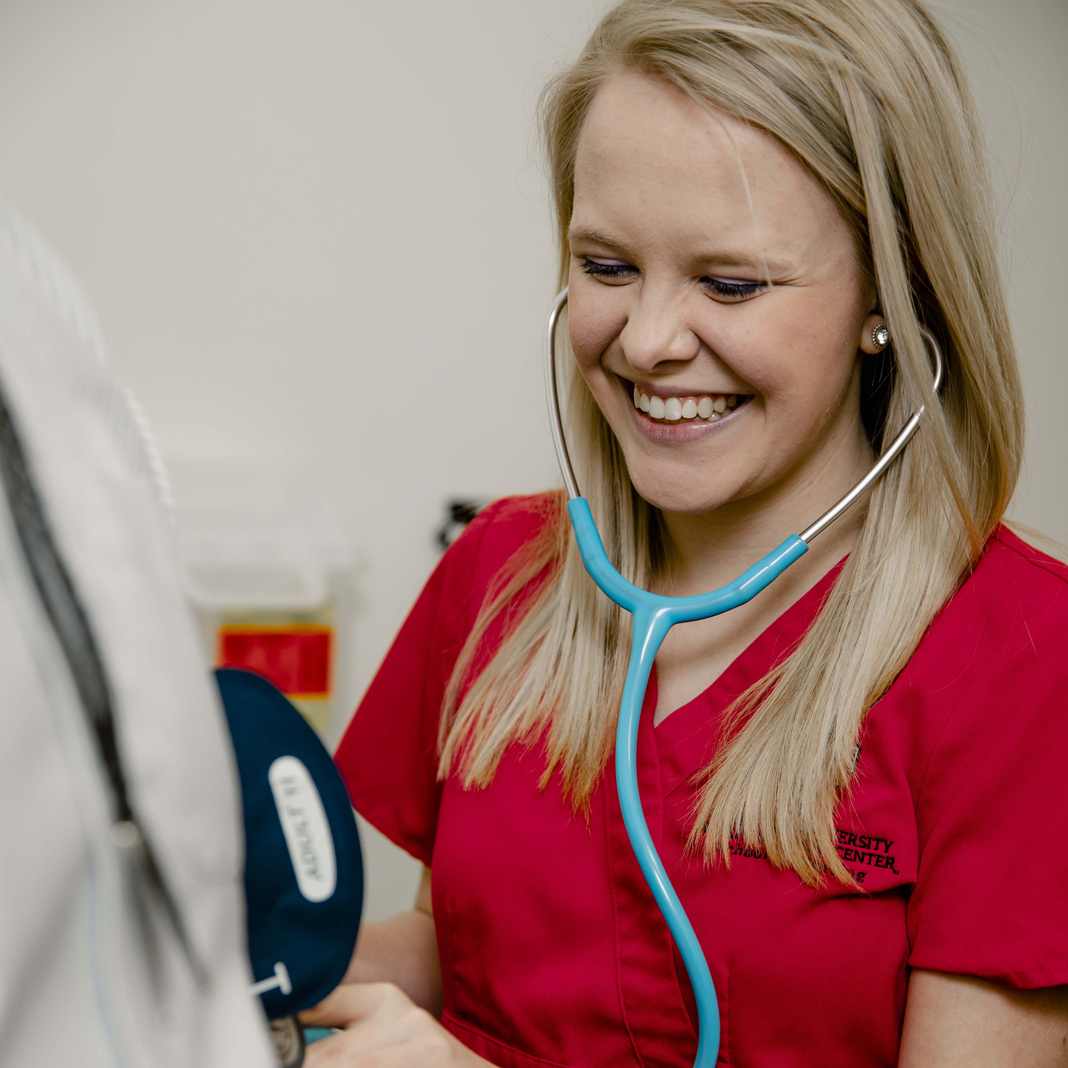 Female nursing student with patient