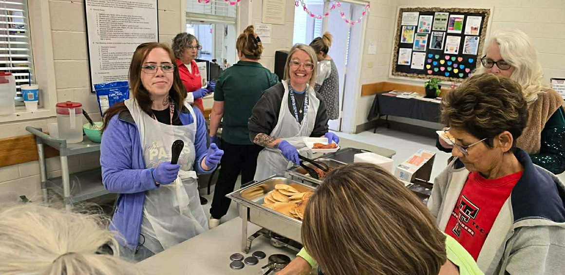 Garrison Institue on Aging team members serving breakfast to residents at a facility