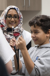 Child holding stethoscope at a TTUHSC sponsored event
