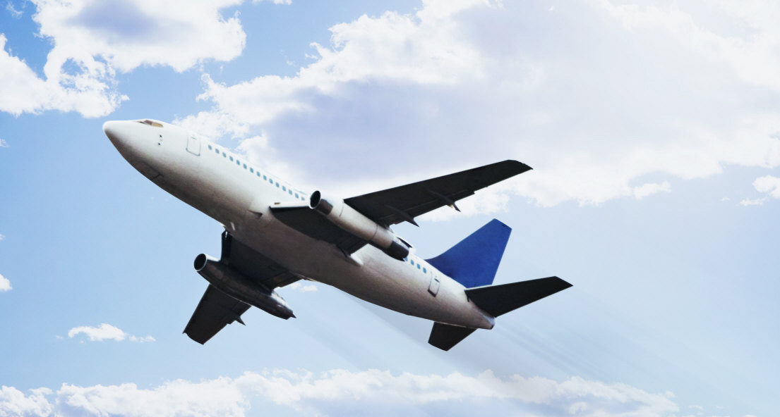 airplane flying through blue skies