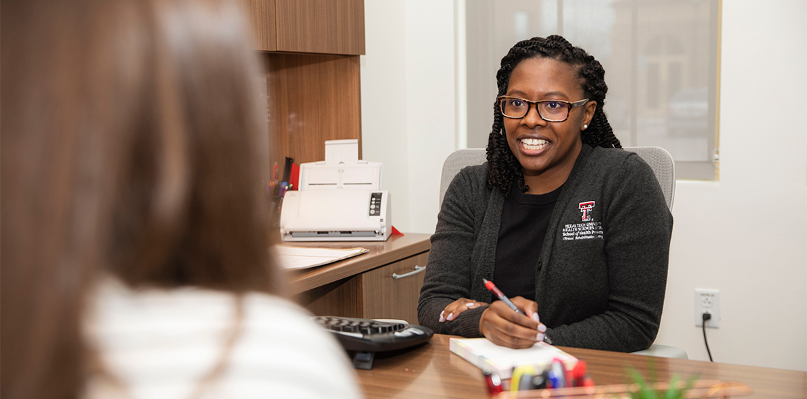 Faculty member speaking to a student