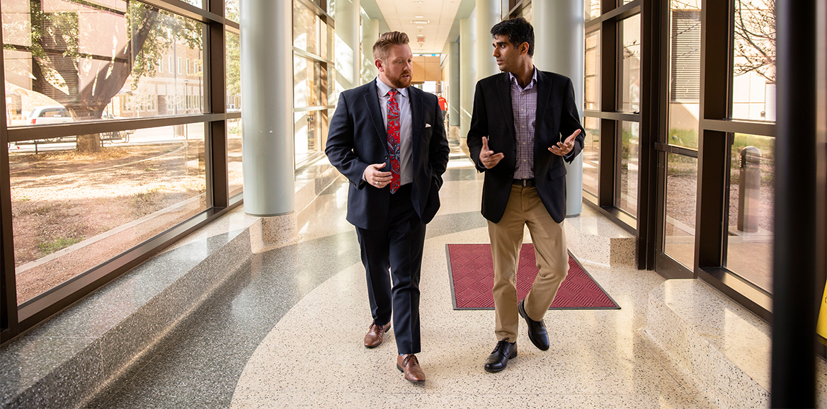 An instructor and colleague having a friendly discussion