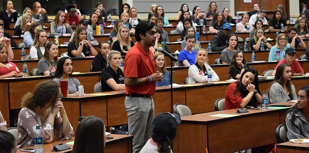 A student asks the panel a question during an ELS event