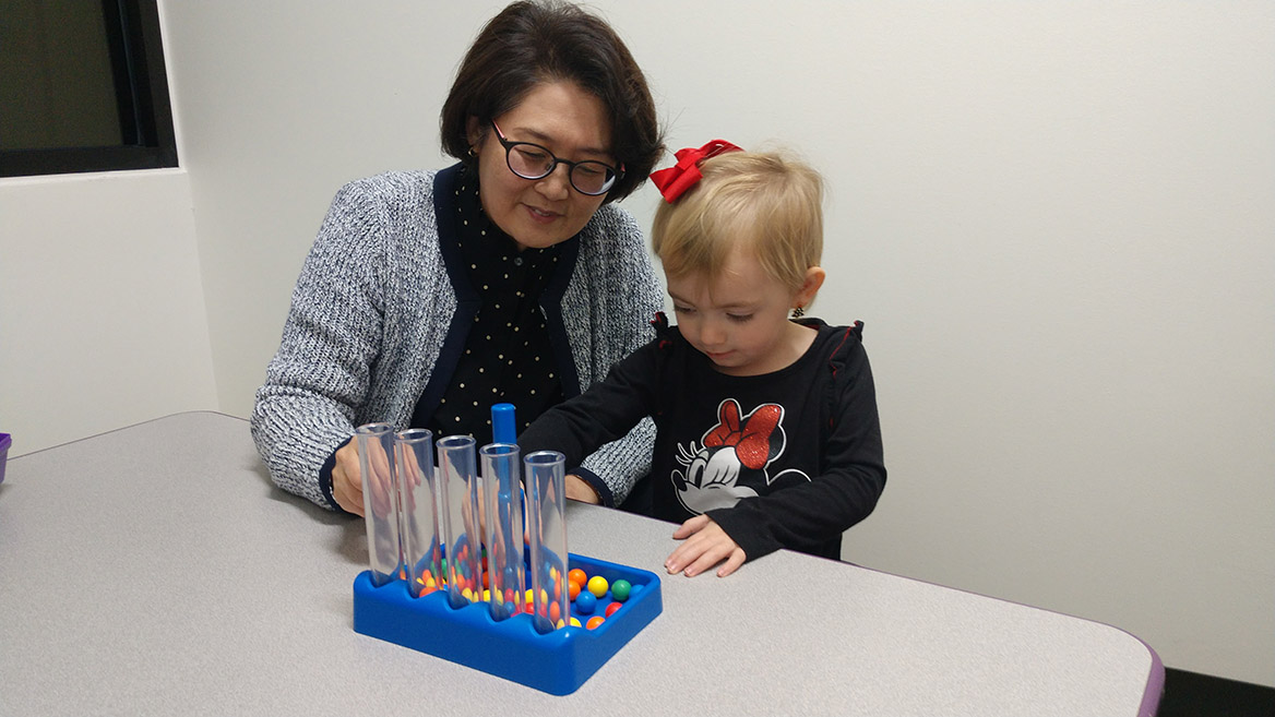 Dr. Lee works with a child in the clinic