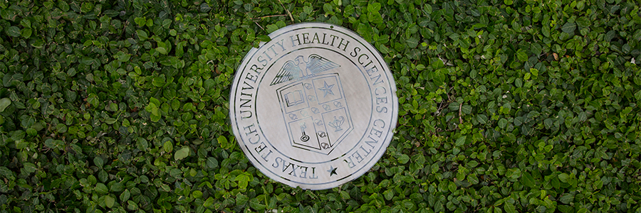 TTUHSC seal laying in greenery