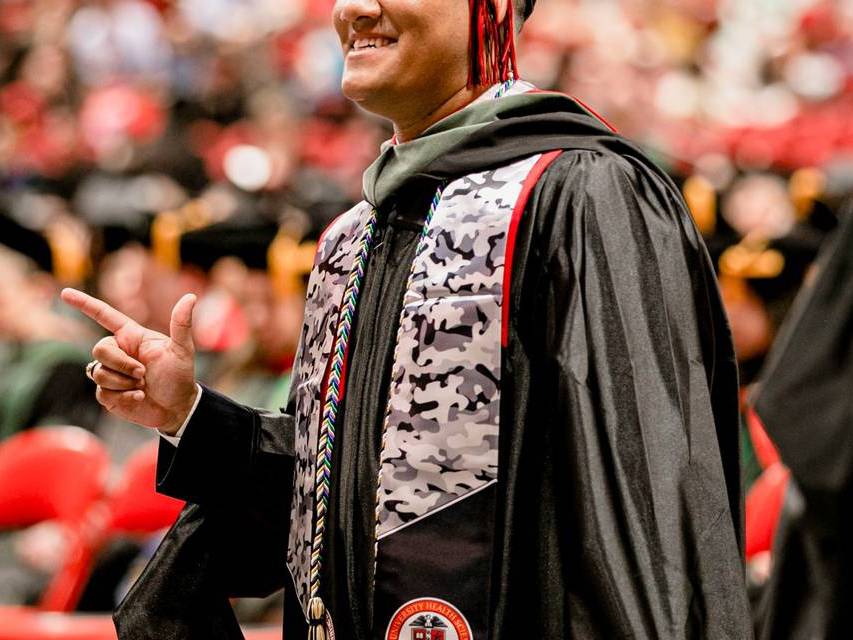 TTUHSC veteran student walking to the stage during commencement