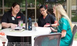 TTUHSC students on the patio outside of the Academic Classroom Building
