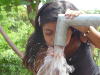 Little girl drinking clean water after well was successfully dug in El Salvador,