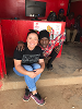 Tonnie and San Juanita outside Tonnie's business kiosk in Masaka.