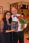 TTUHSC Neurology award presentation with plaque and flowers.