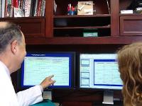 TTUHSC Neurology Resident with faculty reviewing notes on a computer screen.