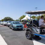 Line of cars for parade following the golf cart lead