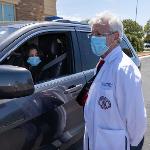 Dean Berk talking to student in car