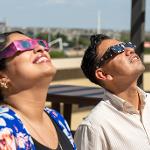 People wearing eclipse glasses