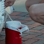 Goin' Band member filling water jug