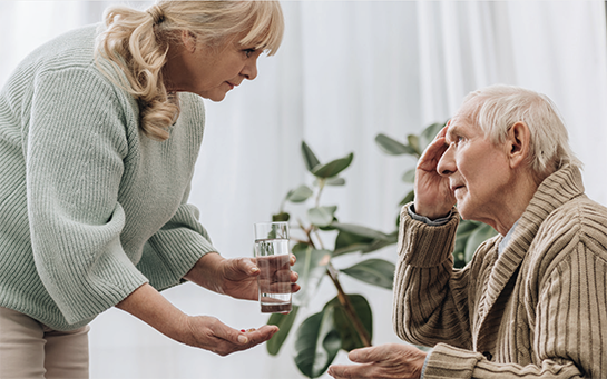 image of woman caring for elderly man