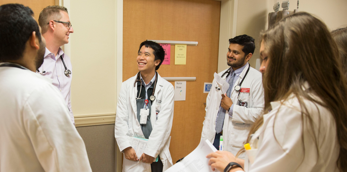 TTUHSC residents during rounds in hallway in discussion.