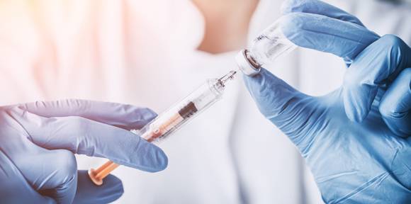 image of nurse holding syringe of vaccine