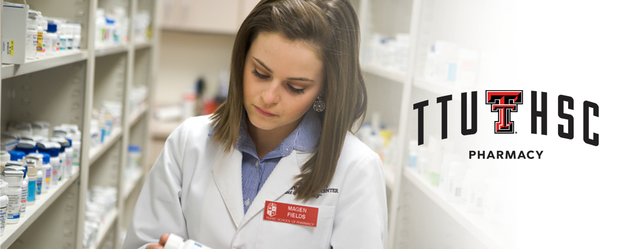 Working in pharmacy looking at medications with TTUHSC Pharmacy logo
