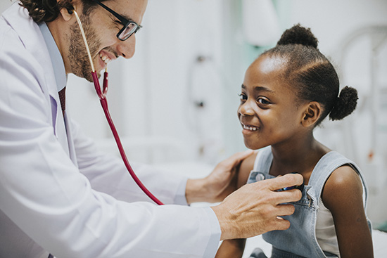 nurse practitioner with young girl and stethoscope