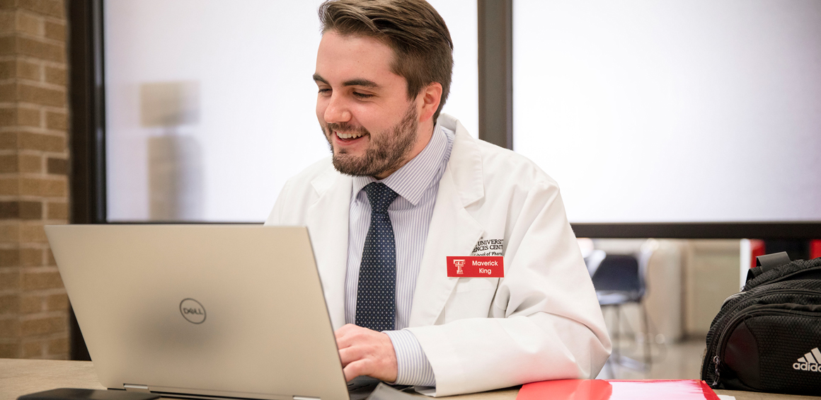 TTUHSC Pharmacy student sitting at desk with computer.