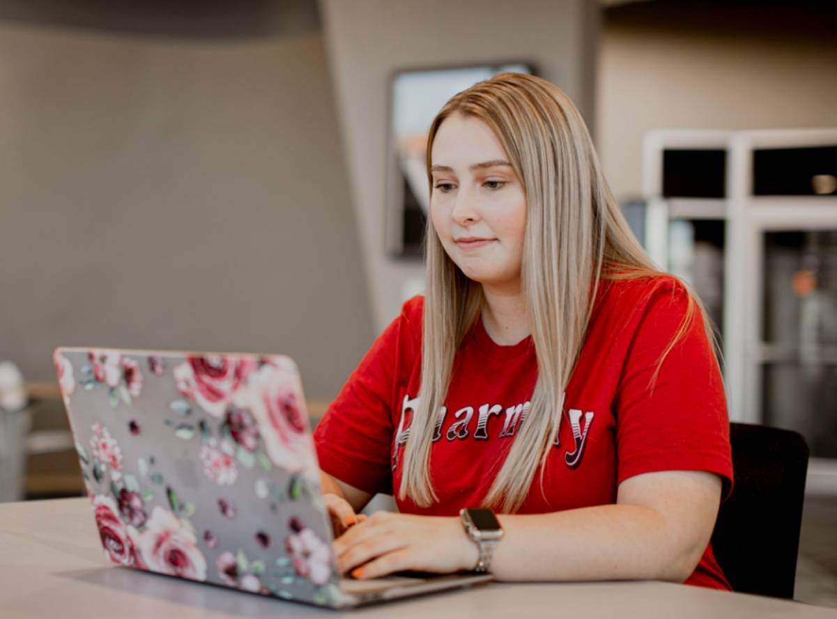 Student in lounge on laptop