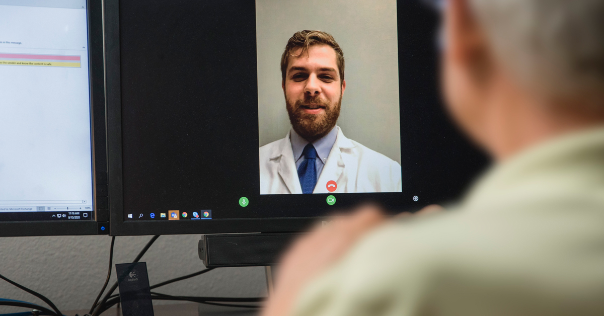 male patient visiting with a physician using telehealth