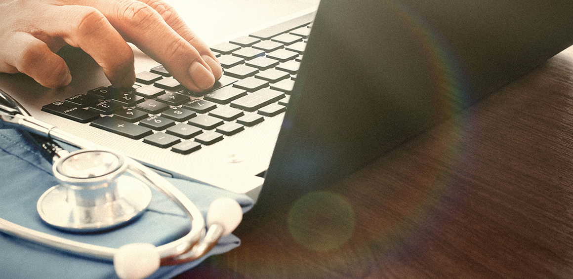 Image of a doctor at a laptop.