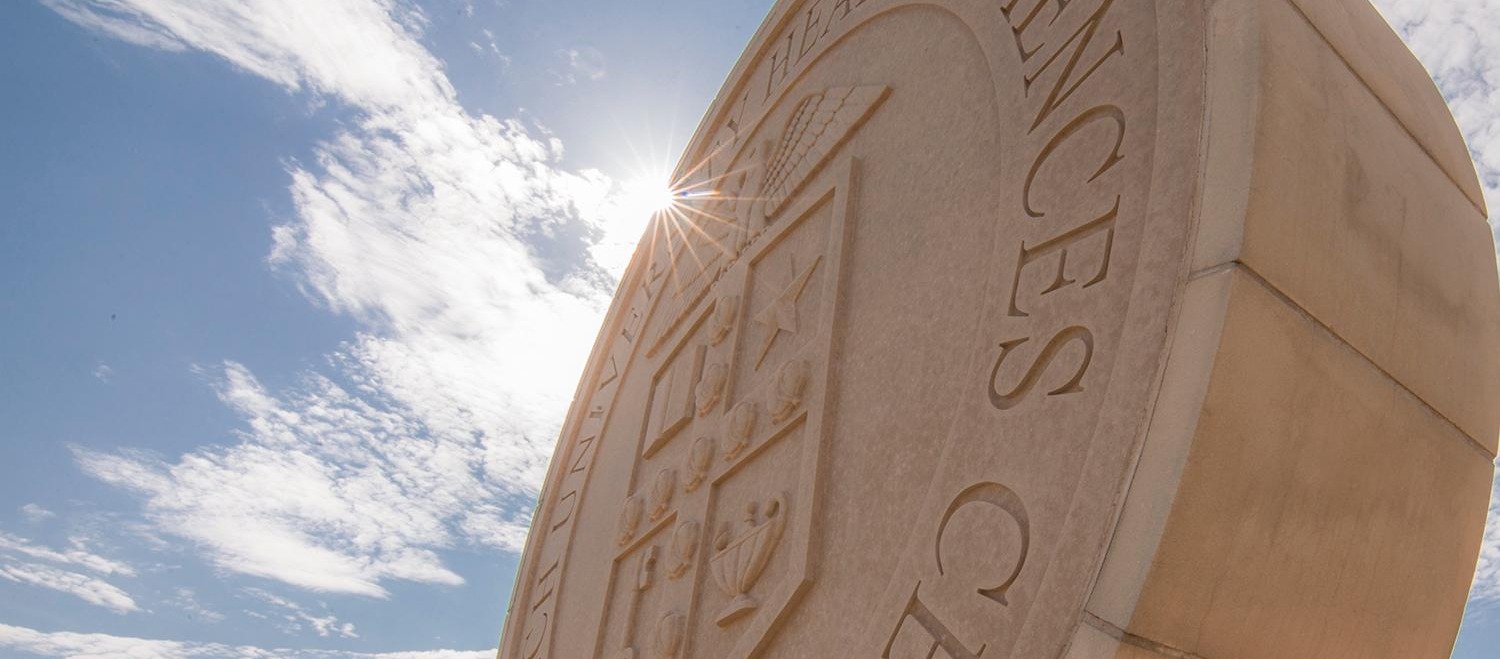 Picture of a stone statue of the Texas Tech University Health Sciences Center seal