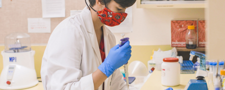 Team Member in research lab with mask