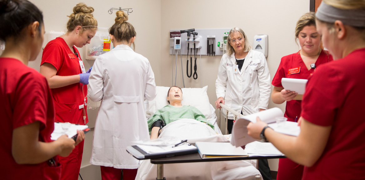 students in simulation lab on TTUHSC campus with manikin