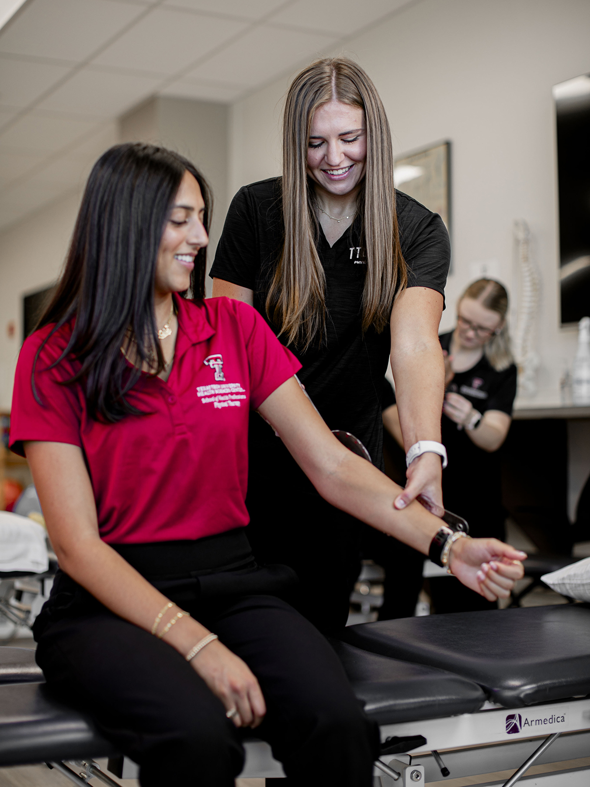 TTUHSC Odessa Physical Therapy students examining person's extended arm