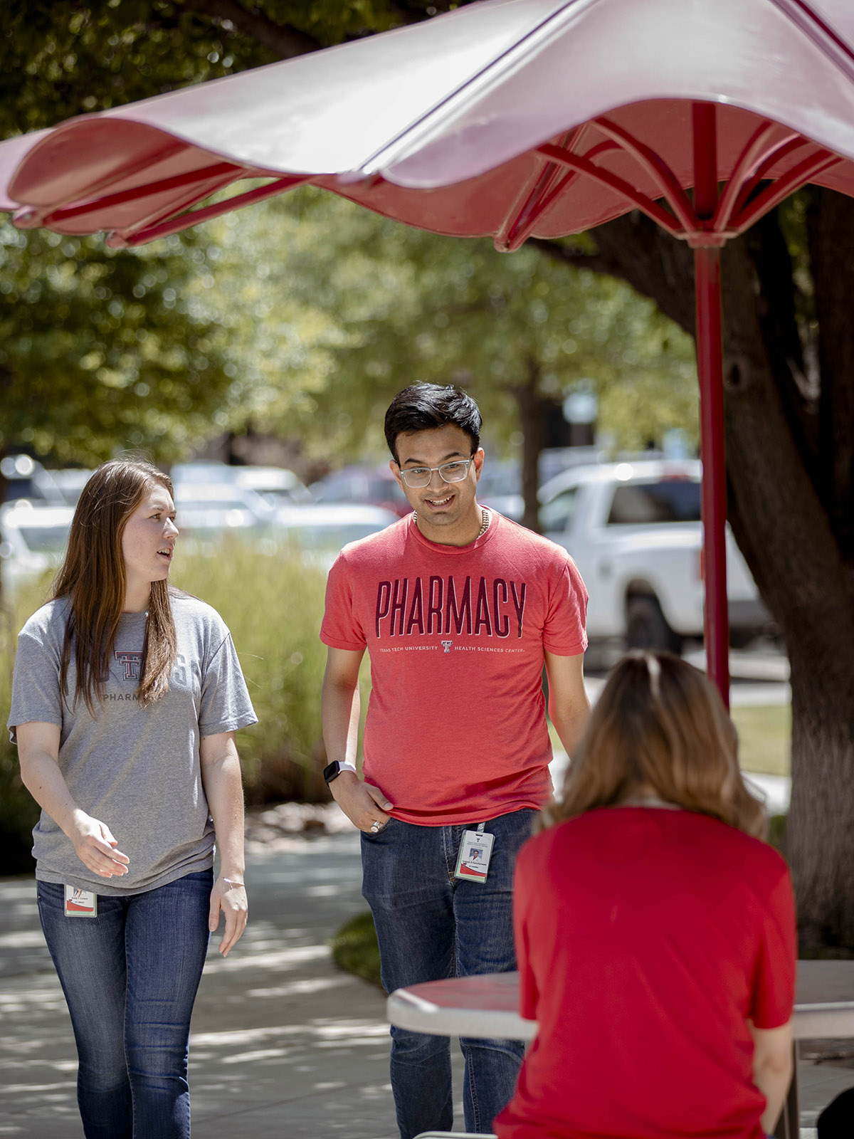 TTUHSC Amarillo students sitting outside wearing a Pharmacy tshirt.