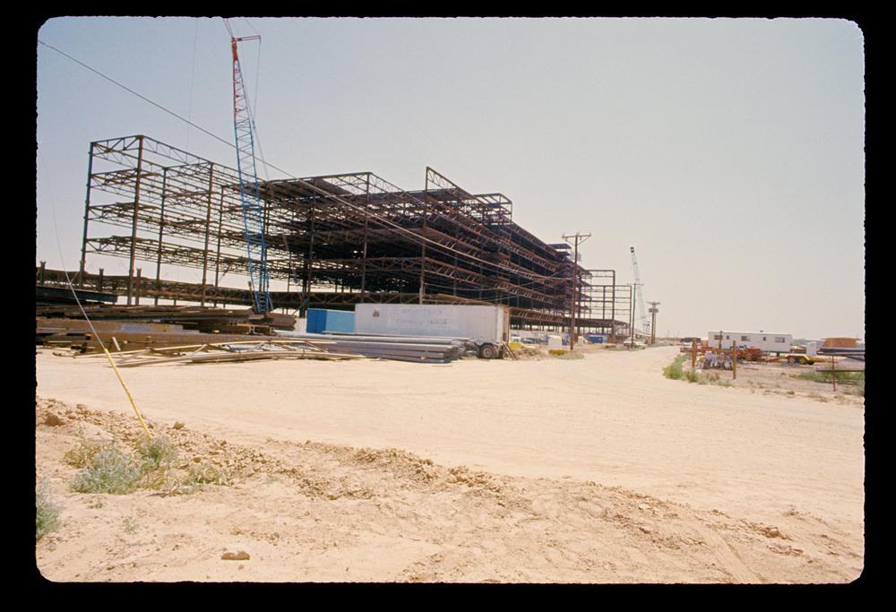 Medical school building under construction in 1974 in a dirt field.
