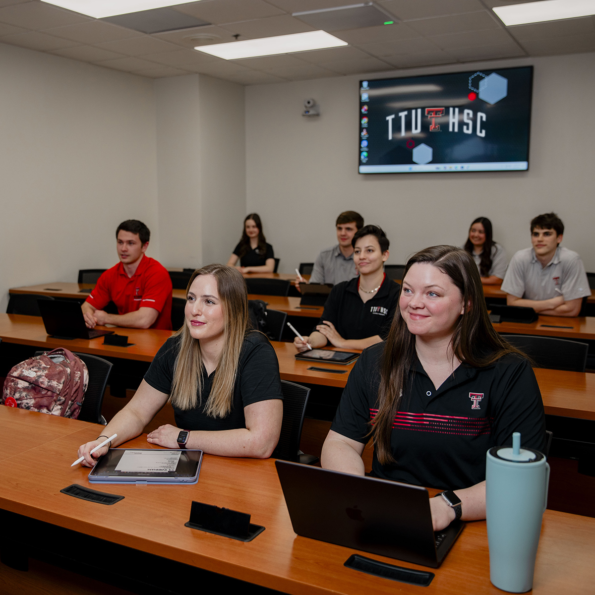 TTUHSC Amarillo students sitting in classroom table rows looking to the front of the room.