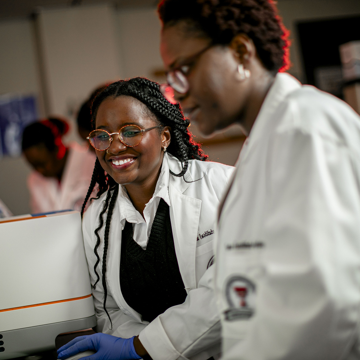 TTUHSC Lubbock Graduate School of Biomedical Science students in white coats smiling in a lab