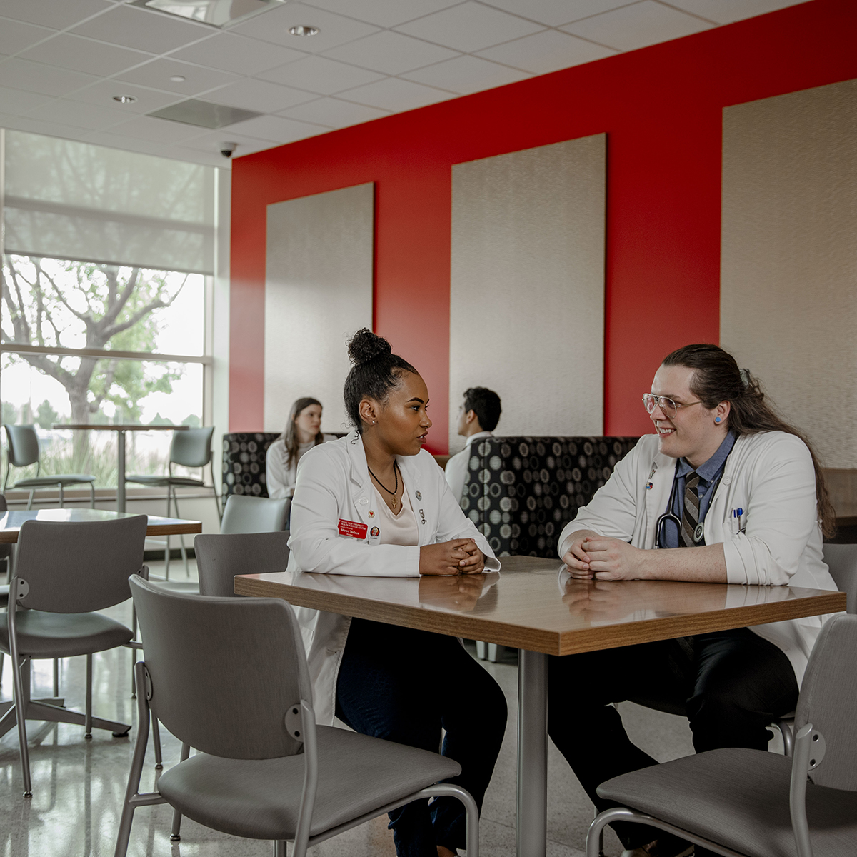 TTUHSC Odessa medical students sitting together at a table in a lounge