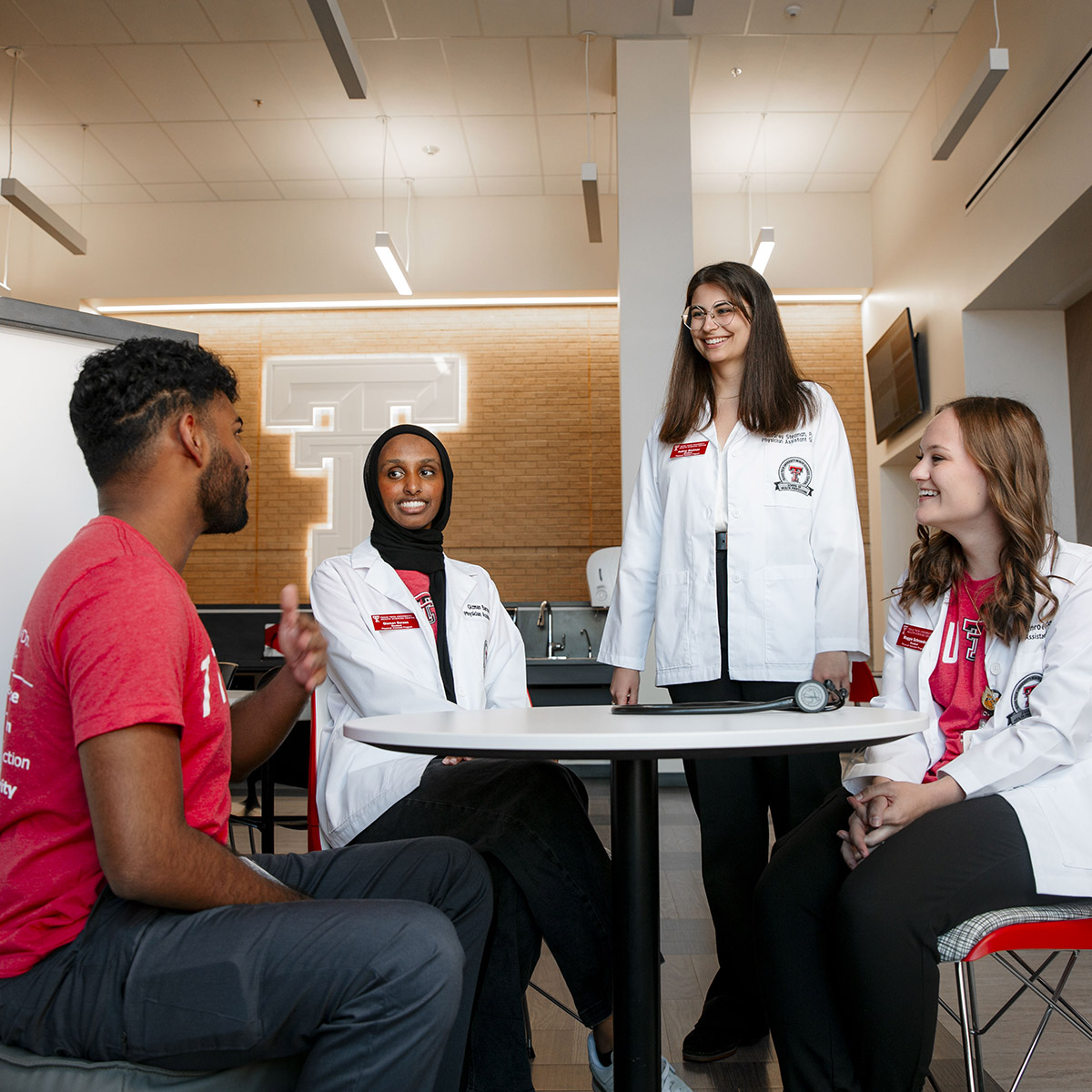 TTUHSC Midland students standing and sitting together at a table