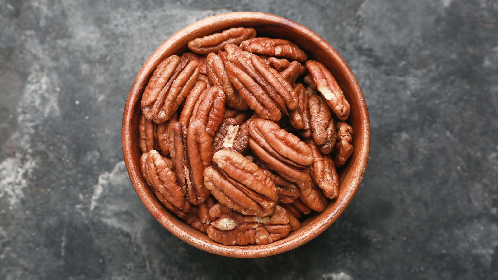 Bowl of pecans sitting on a table