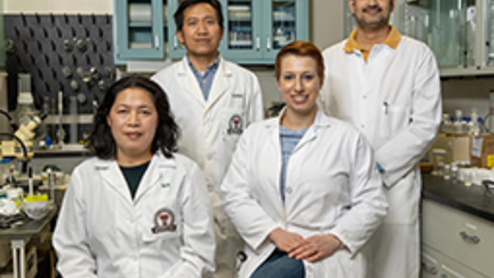 Hongjun (Henry) Liang, Ph.D., with his team in a lab