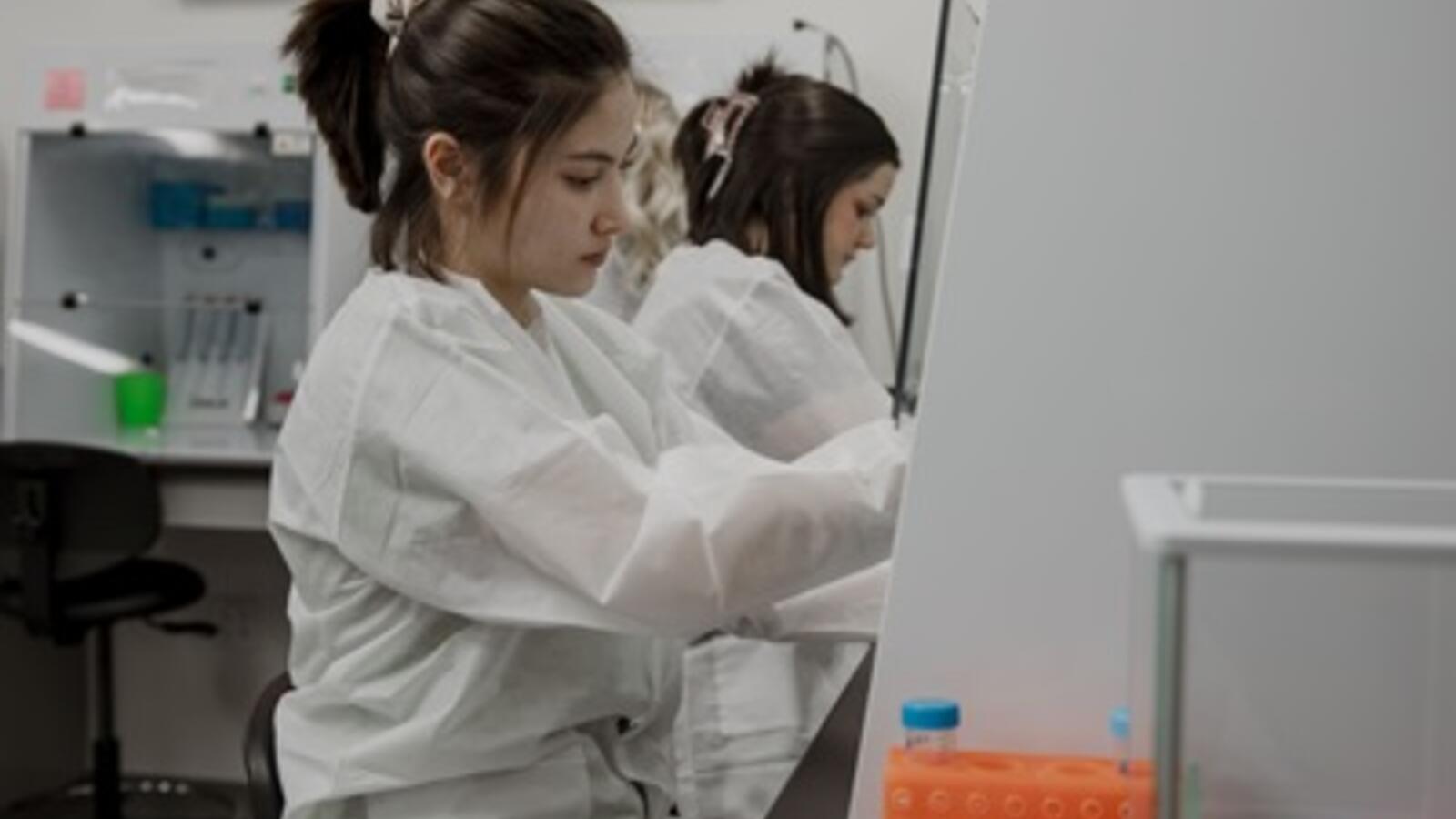 Women working in a lab as molecular genetic technologists