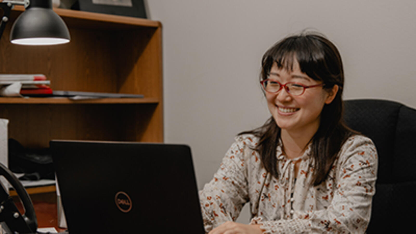 health care professional working at a laptop