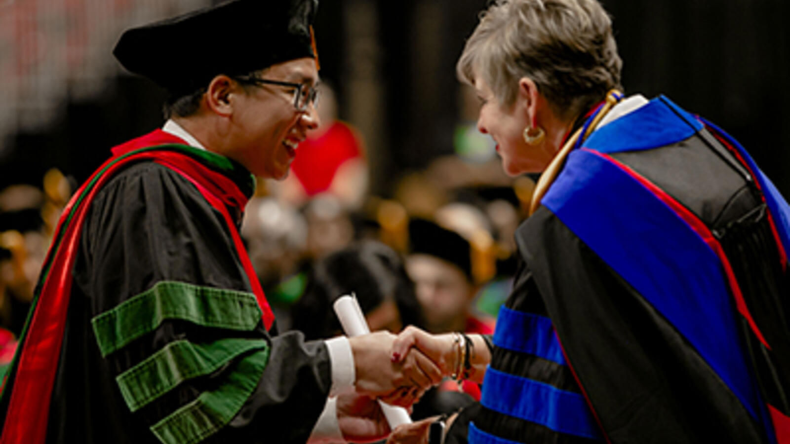 graduate shaking hands with TTUHSC president Lori Rice-Spearman