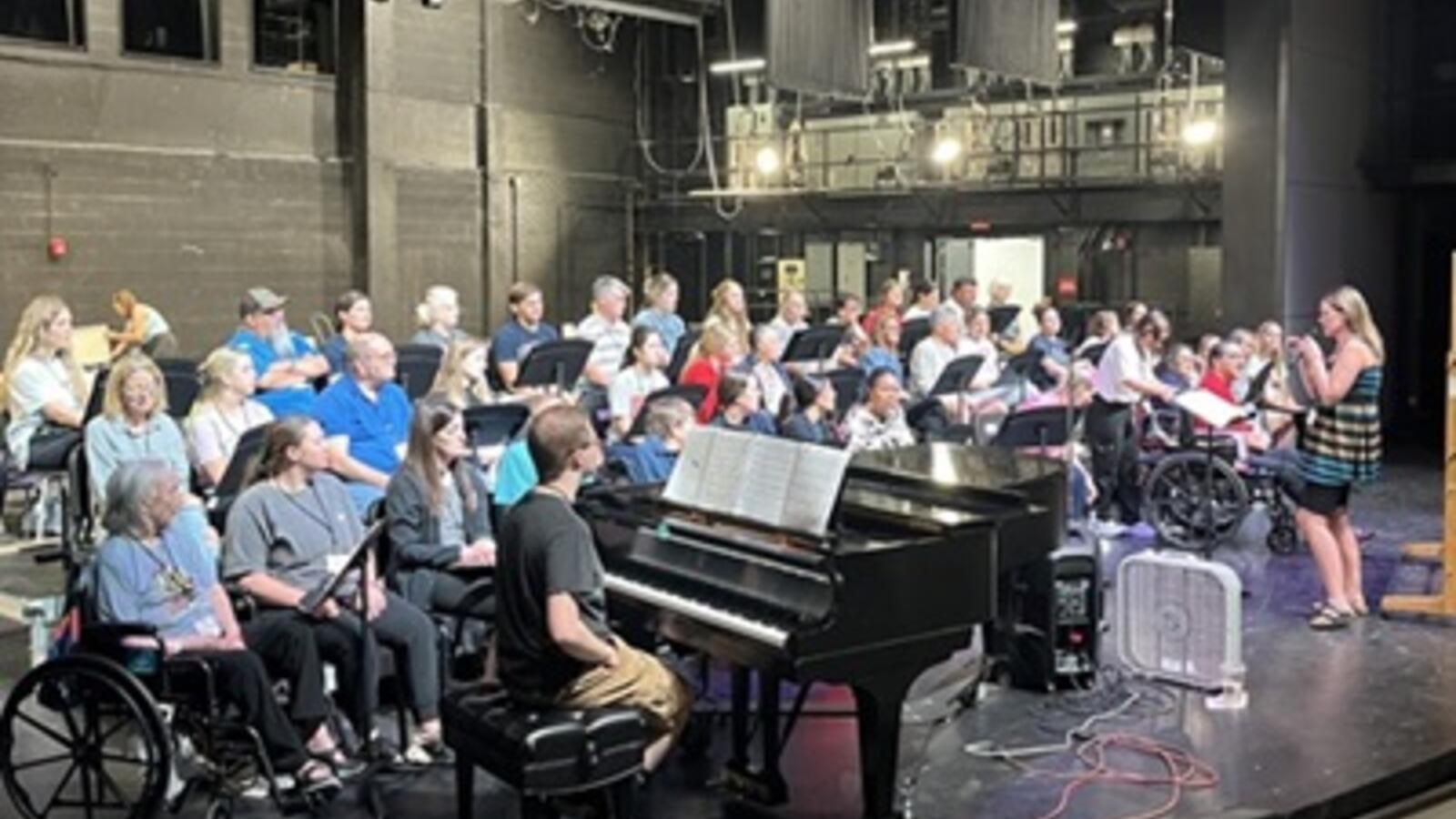 STAR choir summer camp students sitting on a stage