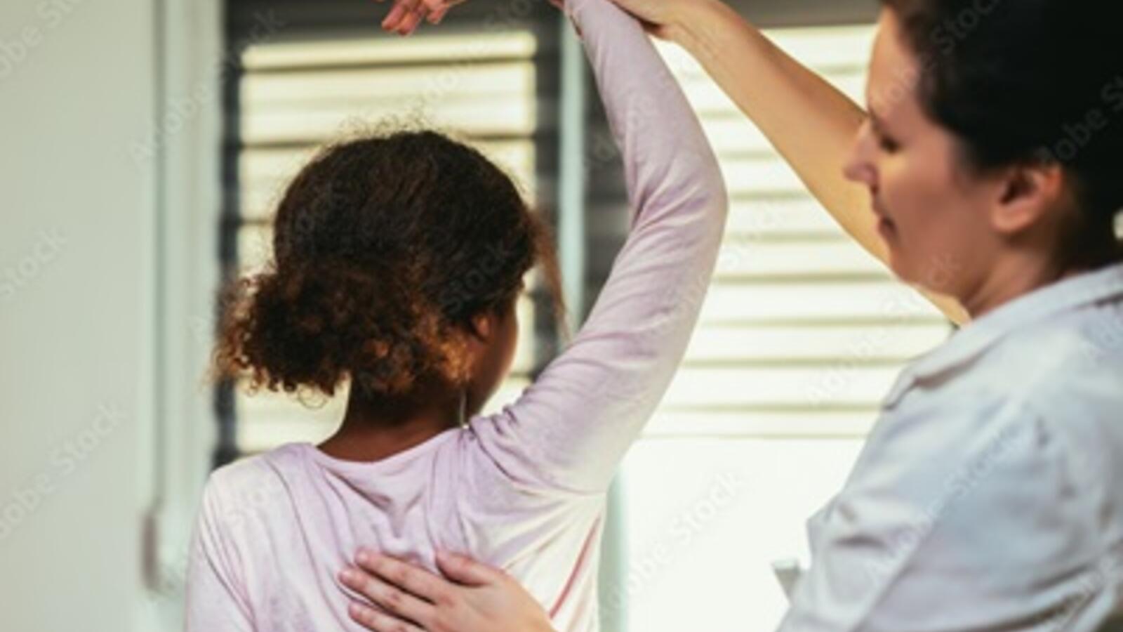health care professional working on mobility with a child
