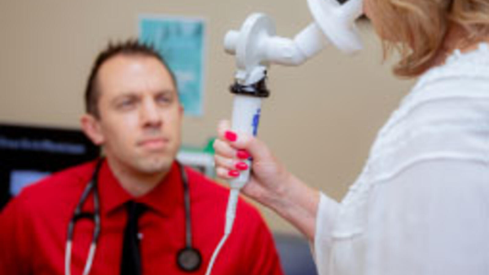 Male doctor treats woman patient with Bronchoscopic Lung Volume Reduction (BLVR) device.