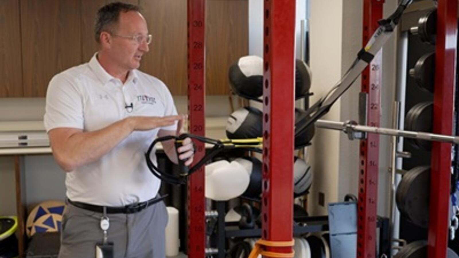 Toby Brooks, Ph.D., using fitness equipment