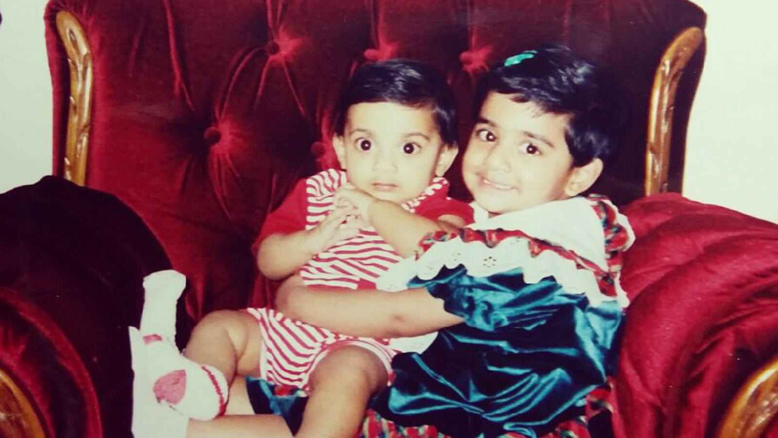 Stacy and Steven Philip as children, sitting together on a chair